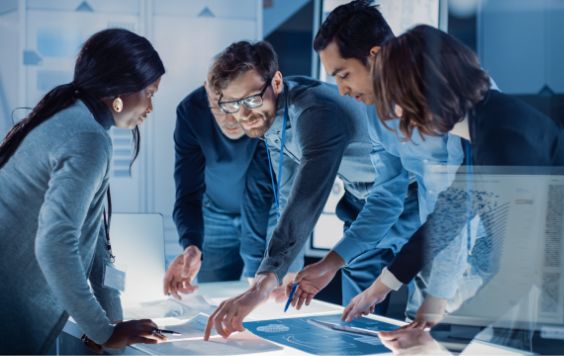 Group of engineers at desk in office